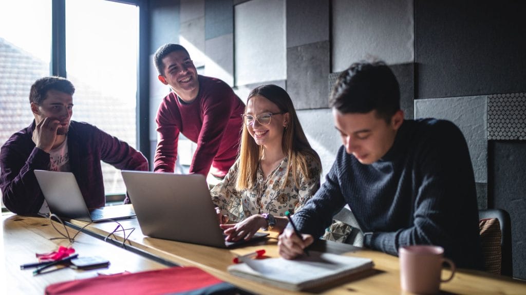 Photo of students working on laptops